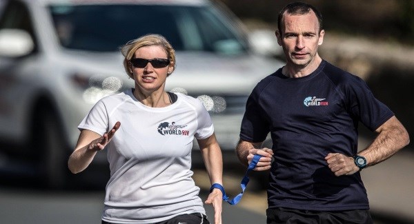Visually Impaired female runner tethered to her male running partner
